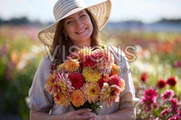 Lady with mixed dahlia bouquet