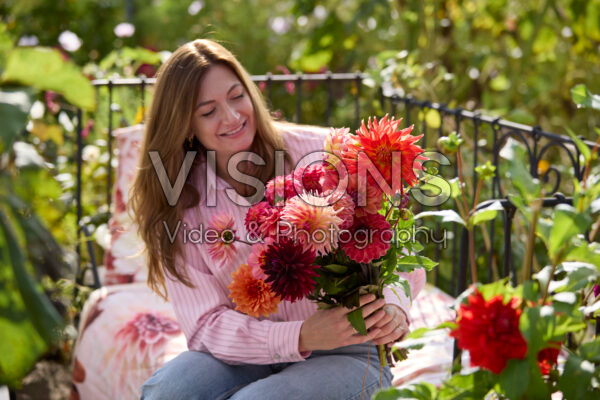 Lady with mixed dahlia bouquet
