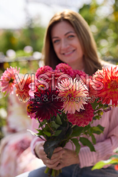 Lady with mixed dahlia bouquet