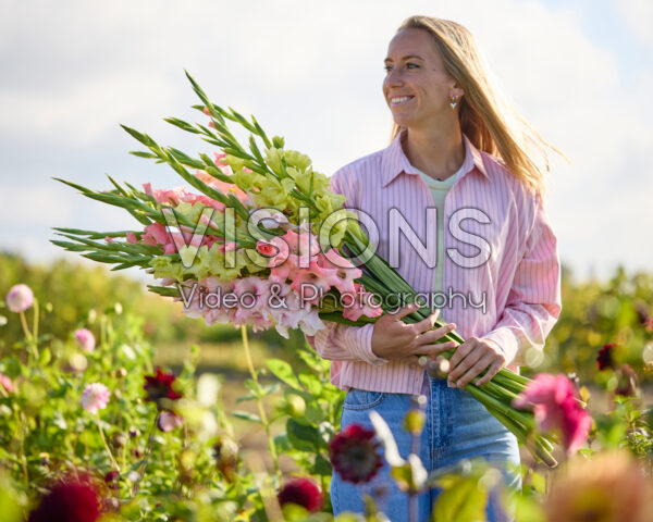 Lady with mixed gladioli bouquet