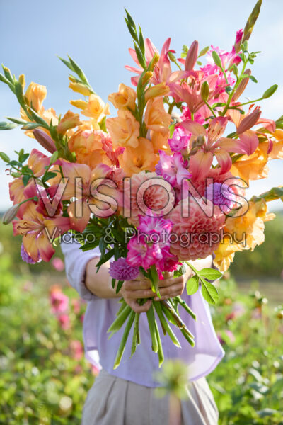 Dame met gemengd zomerbloemen boeket