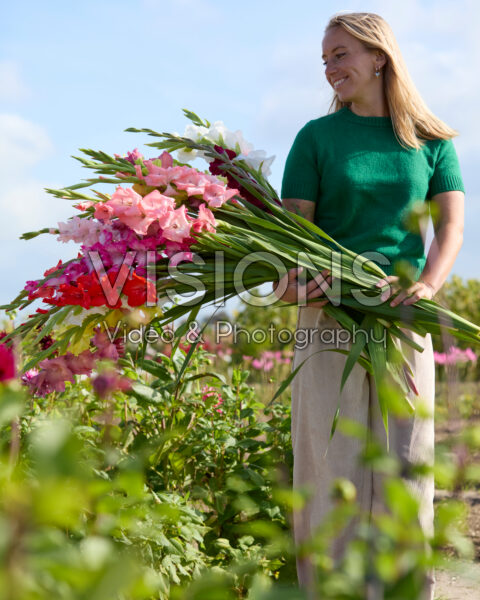Lady with mixed gladioli bouquet
