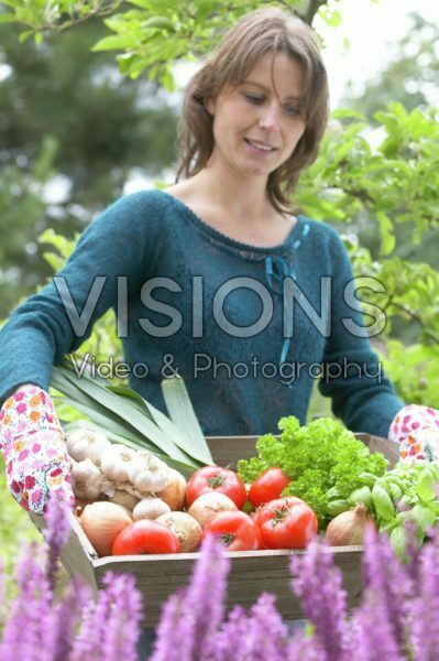 Woman with vegetable harvest