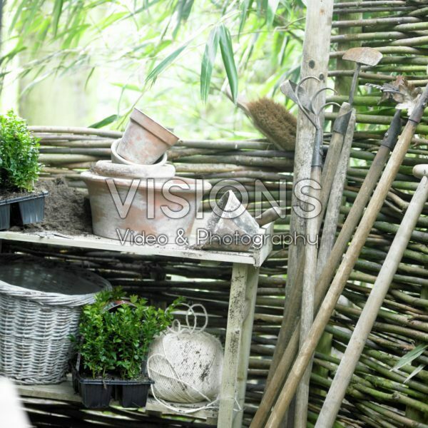 Potting table and tools against willow fence