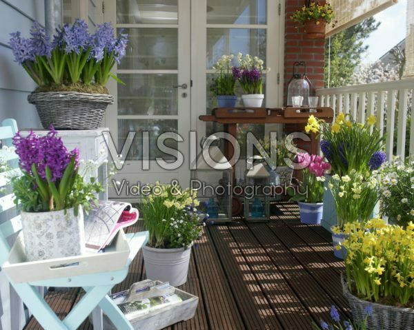Balcony with spring flowers on pots