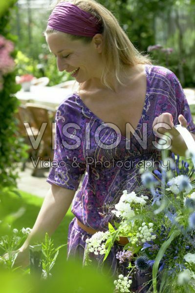 Woman picking summer flowers