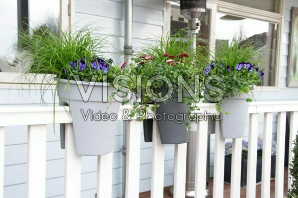 Hanging containers on balcony railing
