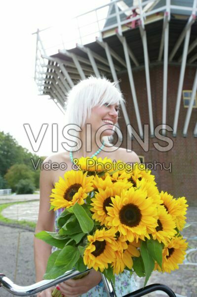 Woman holding sunflowers