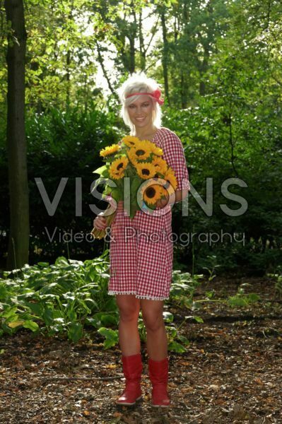 Woman holding sunflowers