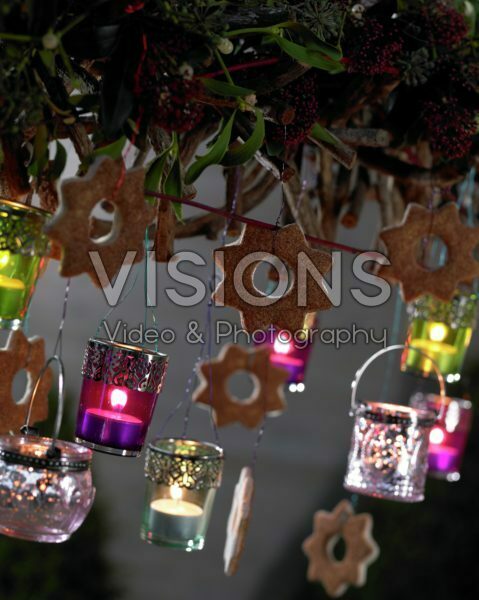 Candles hanging on christmas arrangement