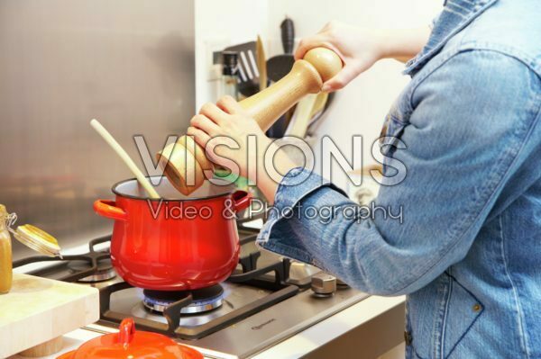 Adding pepper to cooking pan