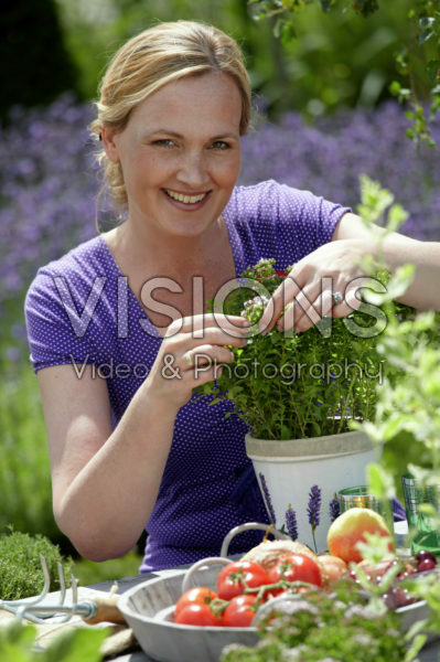 Woman gardening with herbs