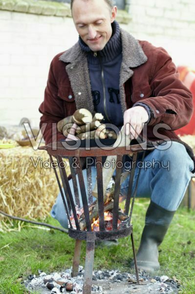 Man adding wood to fire