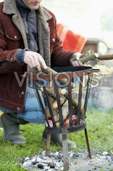 Man adding wood to fire